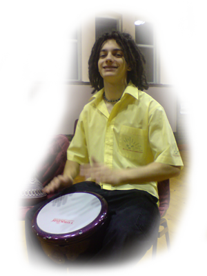 Oliver Parker enjoying a school drumming workshop playing along with a hand drum.